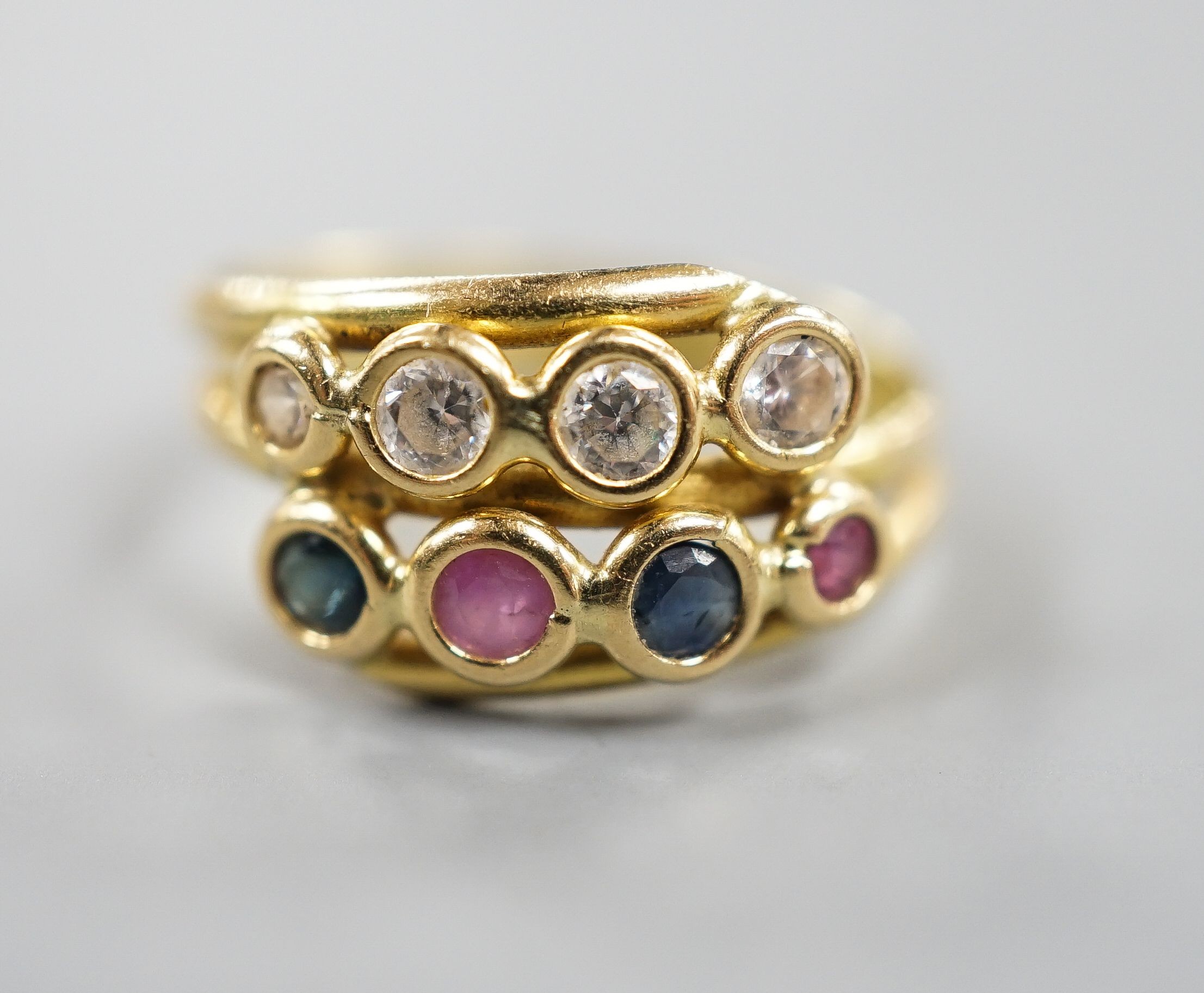 A modern Italian 750 yellow metal and collet set four stone diamond, two stone sapphire and two stone ruby set two row ring, size J/K gross 2.8 grams.